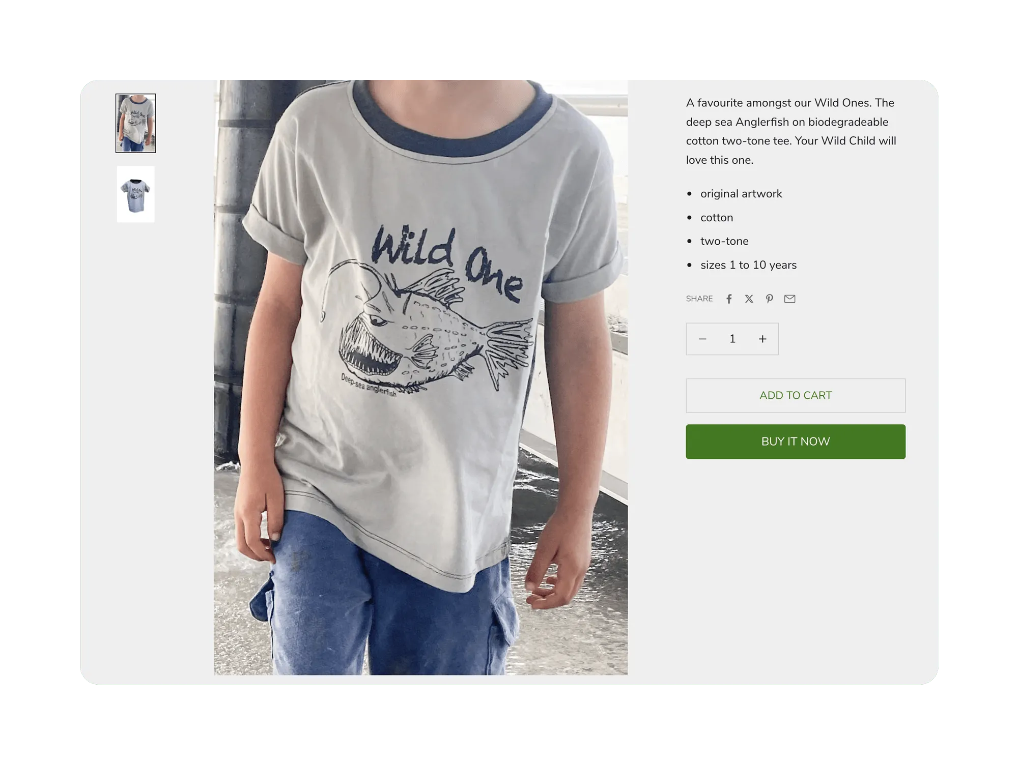 Desktop product page: child modeling a two-tone anglerfish “Wild One” t‑shirt with size selector and add‑to‑cart option